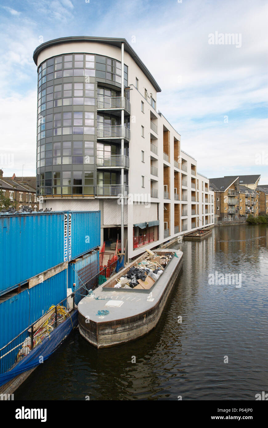 Barge bringing suppliers to a building site next to the Grand Union Canal, Kensal Town, West London, UK Stock Photo