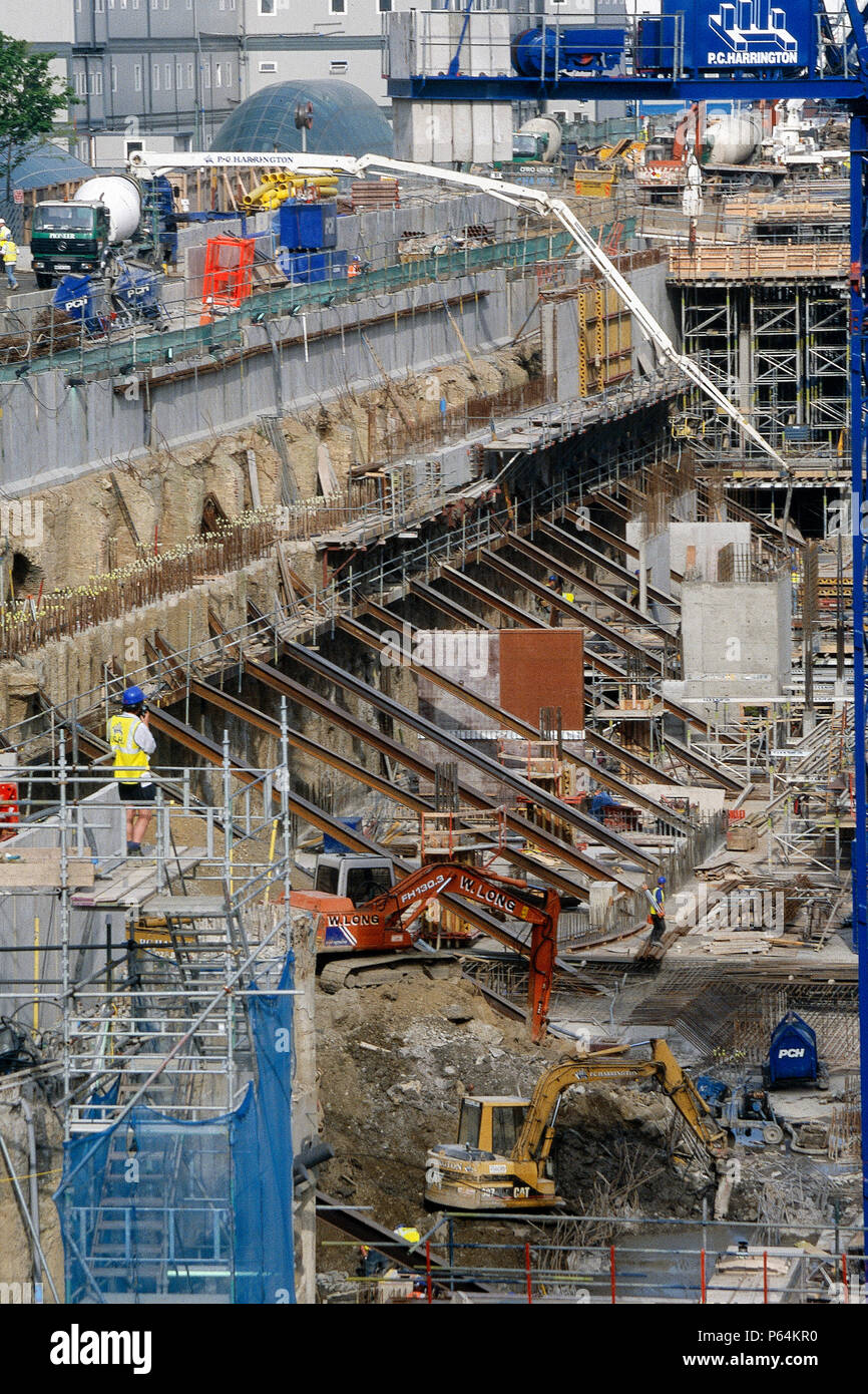 Pumping concrete into foundations of large scale construction site for