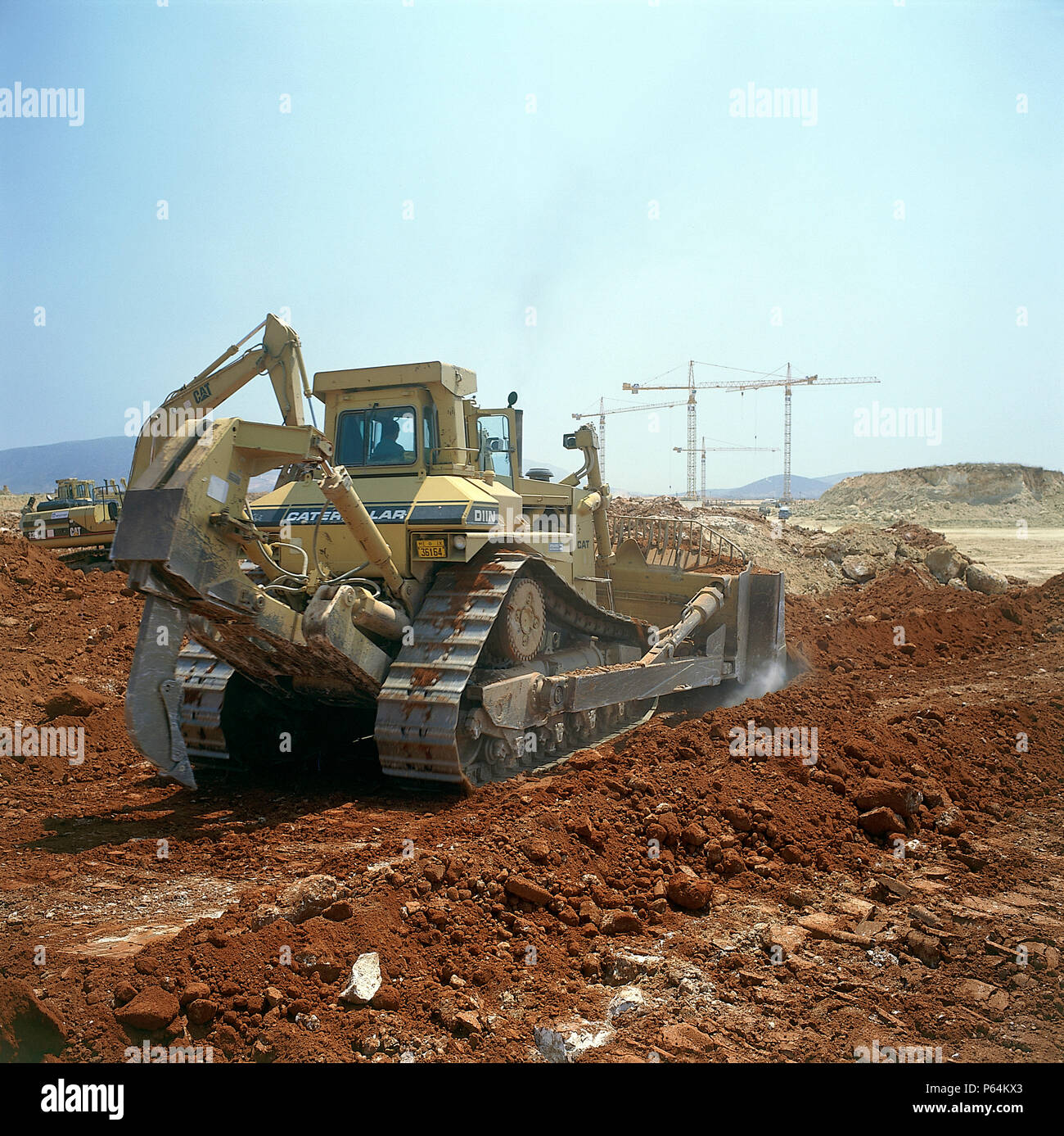 Caterpillar D11N bulldozer using blade and rearmounted ripper