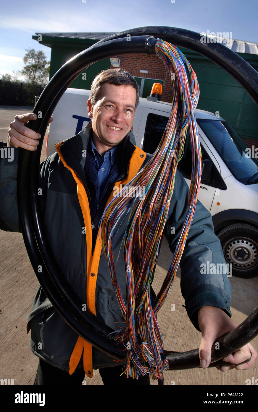 A telecommunications network designer with telephone cables at an exchange, UK Stock Photo