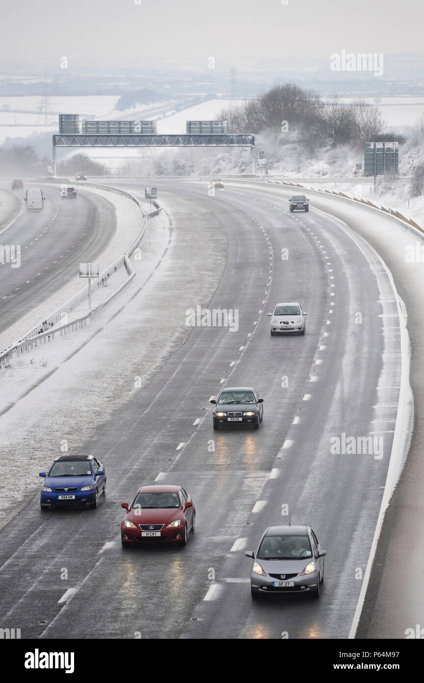 Traffic on motorway in snowy weather, UK Stock Photo
