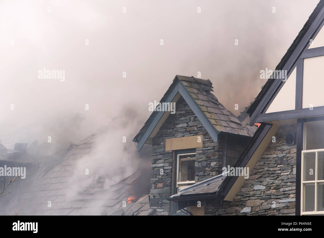 A fire being tackled by firemen in Ambleside UK Stock Photo