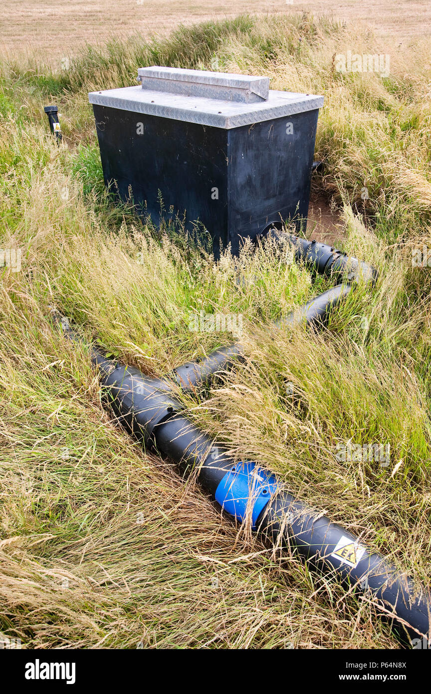 An old rubbish tip on Walney Island in Cumbria where the methane escaping from the decomposing rubbish is being captured and burnt to prevent this hig Stock Photo