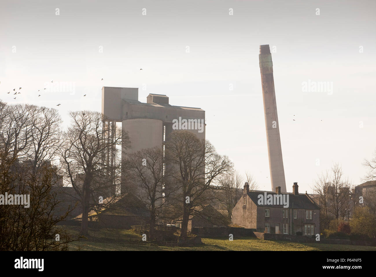 The old chimney at Castle Cement in Clitheroe Lancashire UK being demolished Stock Photo