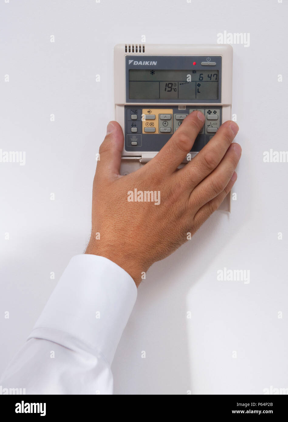 Office worker turning down the heating system Stock Photo Alamy
