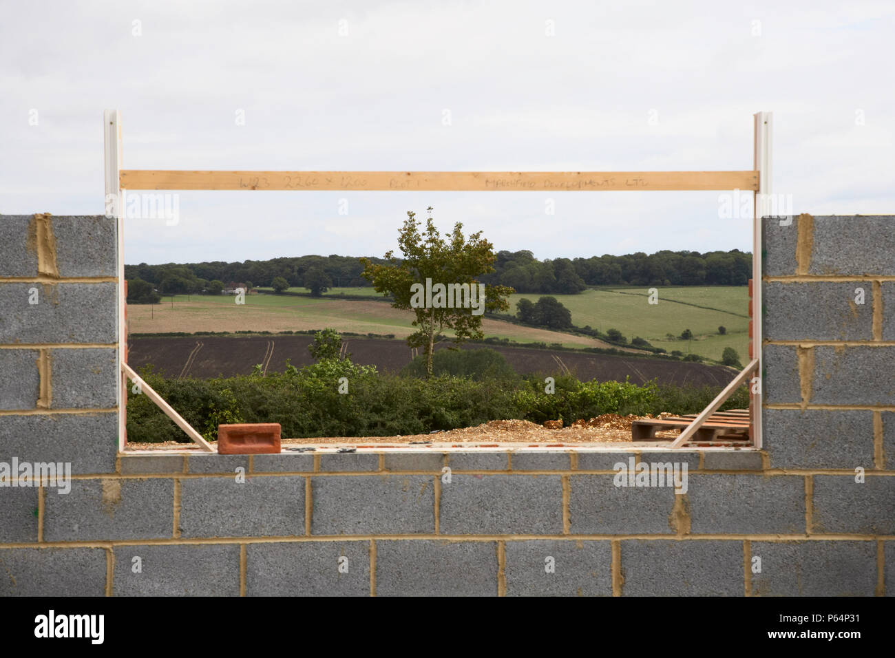 Window frame on a breezeblock wall Stock Photo