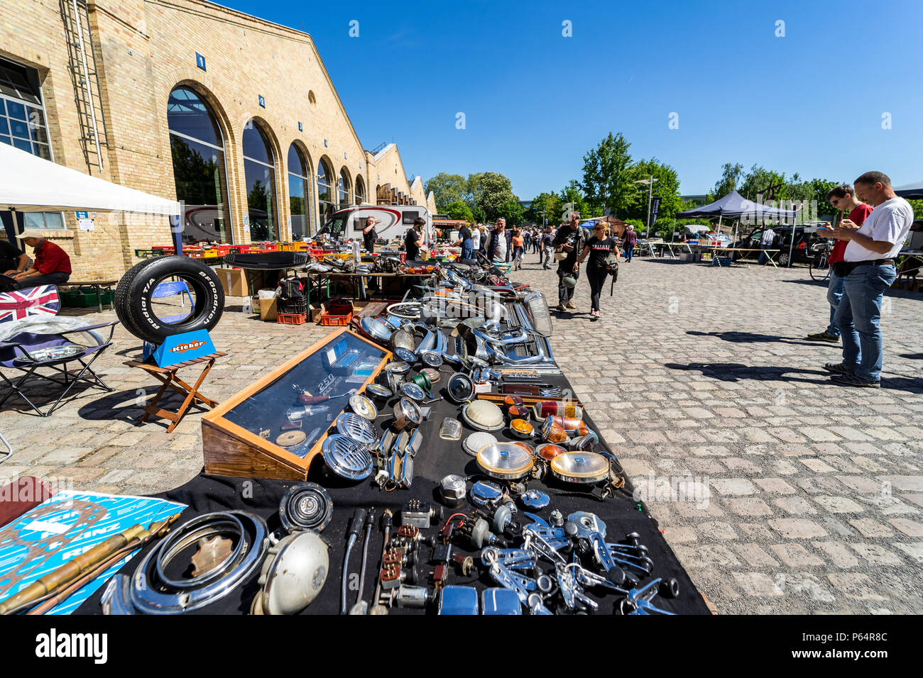 Flea market for the sale of spare parts for old cars in front of the building of the Classic Remise Berlin. Stock Photo