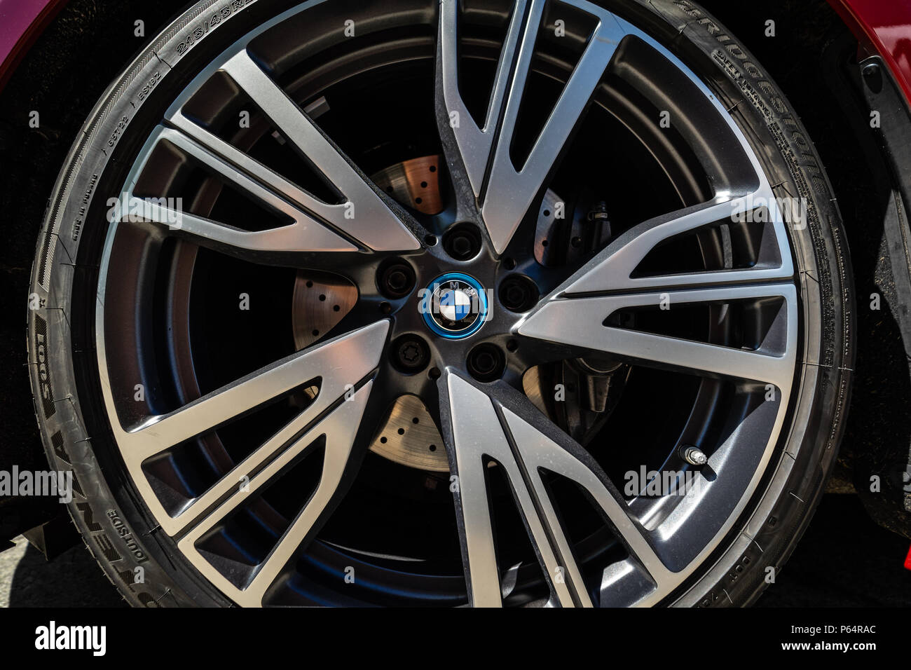Detail of the front brake system of a plugin hybrid sports car BMW i8. Closeup. 31th Berlin