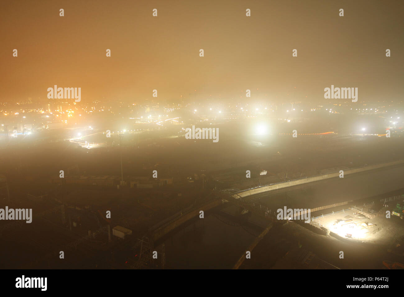 Olympic Stadium during construction, Stratford, London, UK, foggy night, January 2009, looking West Stock Photo