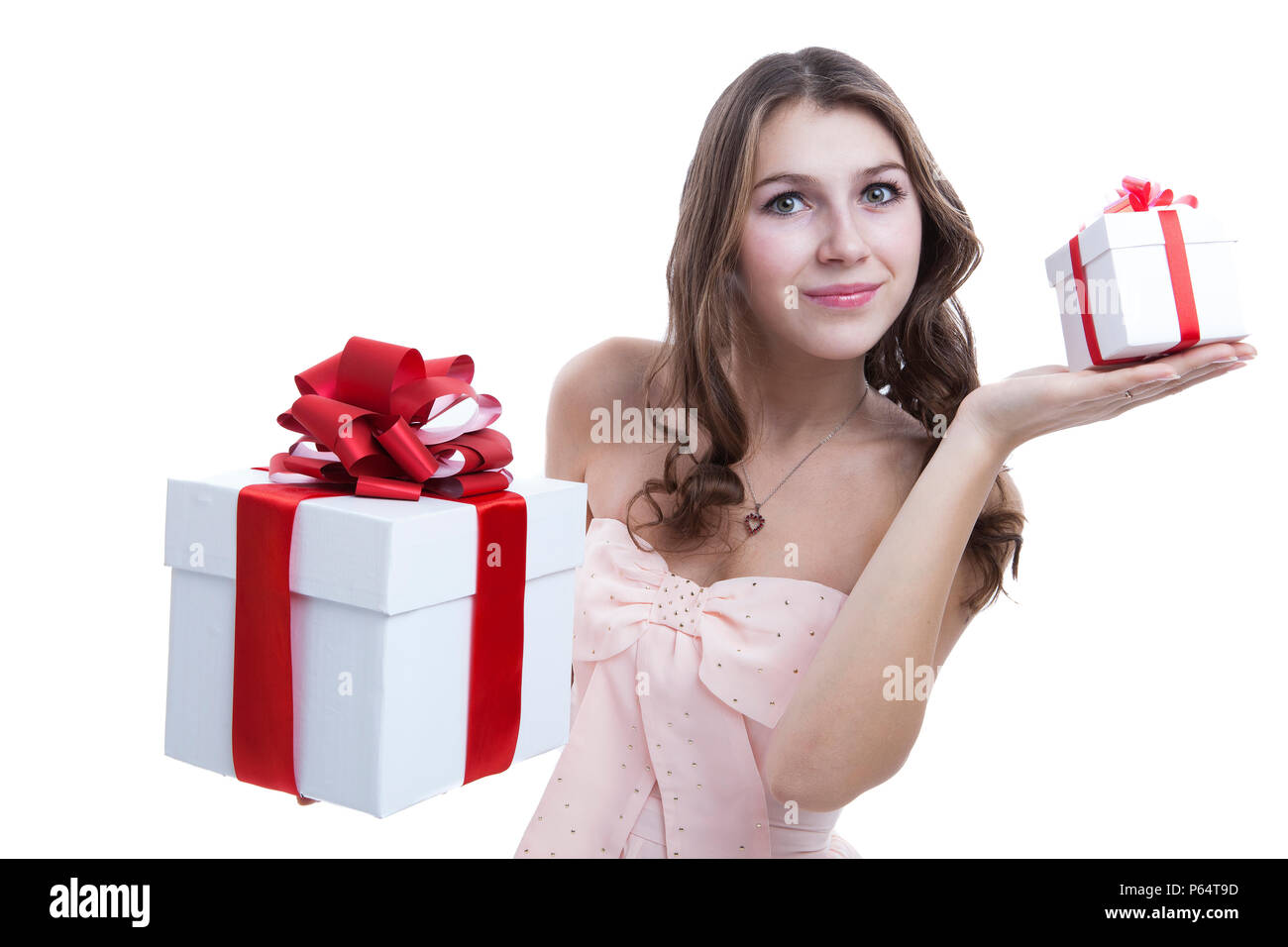 girl in a pink dress holding a gift box on a white background Stock ...