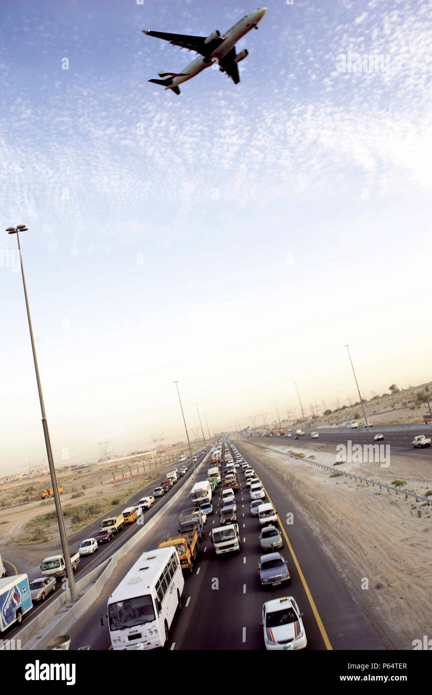 Emirates Road traffic jam, aeroplane flying overhead, Dubai, United Arab Emirates, May 15, 2005. Stock Photo