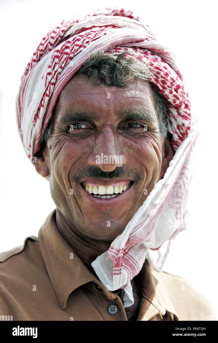 Lal Zaada, a construction worker, talks with an ITP reporter on Sheikh Zayed road, Dubai, United Arab Emirates, July 3, 2005. Stock Photo