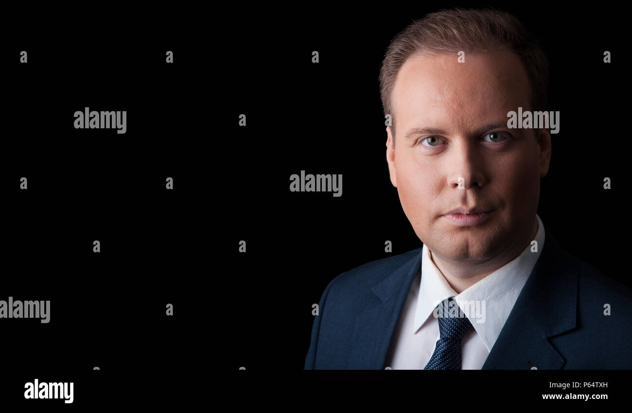 man in a suit and tie on a black background isolated Stock Photo
