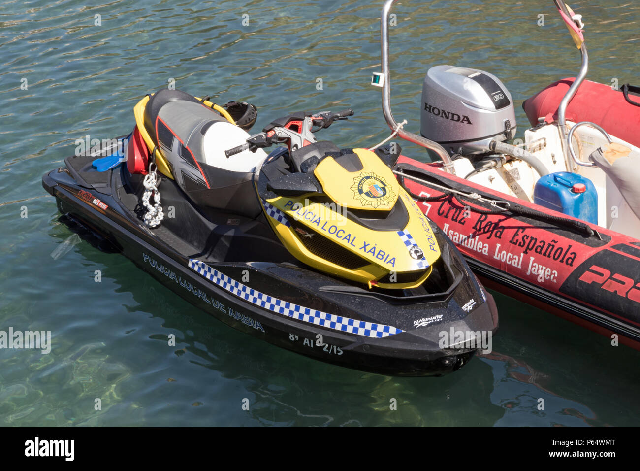 Local police water ski jet moored at Playa La Granadella Javea Stock Photo
