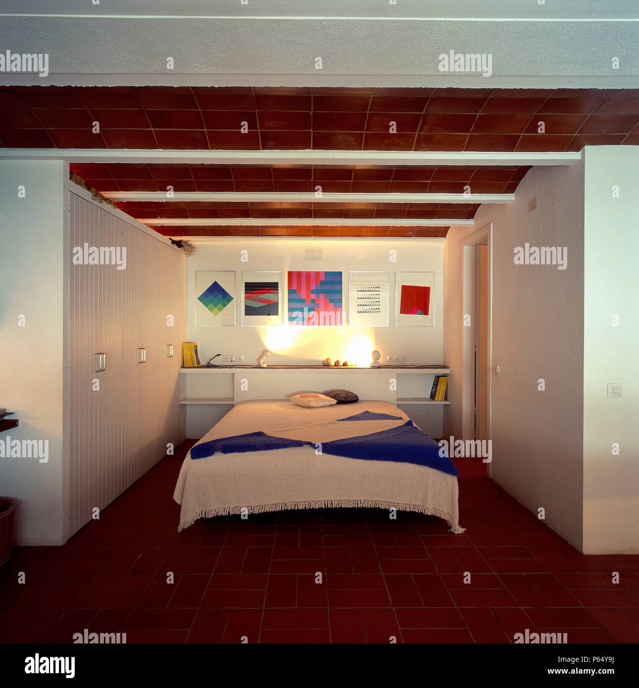 View of a cozy bed in a spacious bedroom Stock Photo
