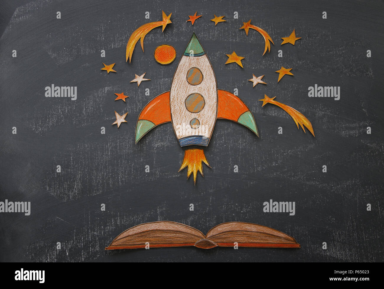 Back to school concept. rocket with pencils, space elements shapes cut from  paper and painted over classroom blackboard background Stock Photo - Alamy