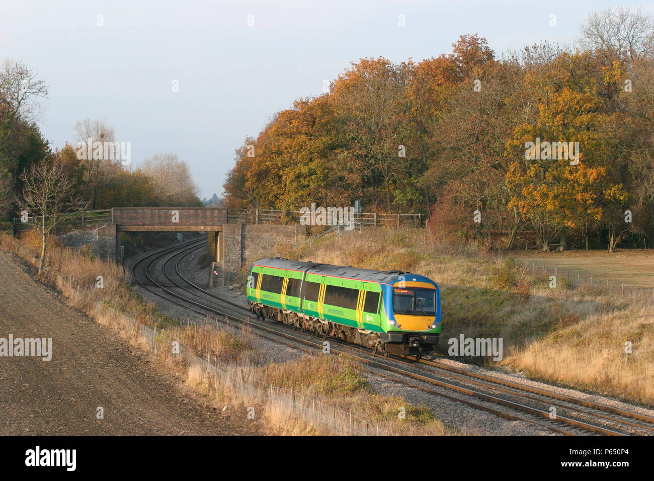 A Central Trains Class 170 Turbostar flits through the autumn tints of Croome Perry Wood in Worcestershire. October 2003. Stock Photo