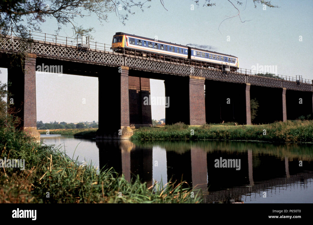 A Class 108 Derby Lightweight DMU crosses the River Ouse at Sharnbrook with a Bedford to Kettering local. May 1992 Stock Photo