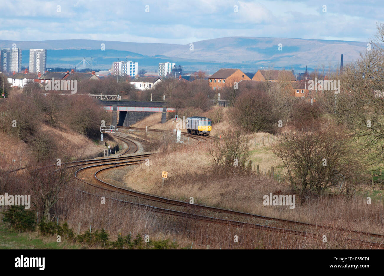 A Class 142 Pacer DMU trainset climbs away from the WCML south of Preston with a Blackpool South - Colne service. March 2005. Stock Photo