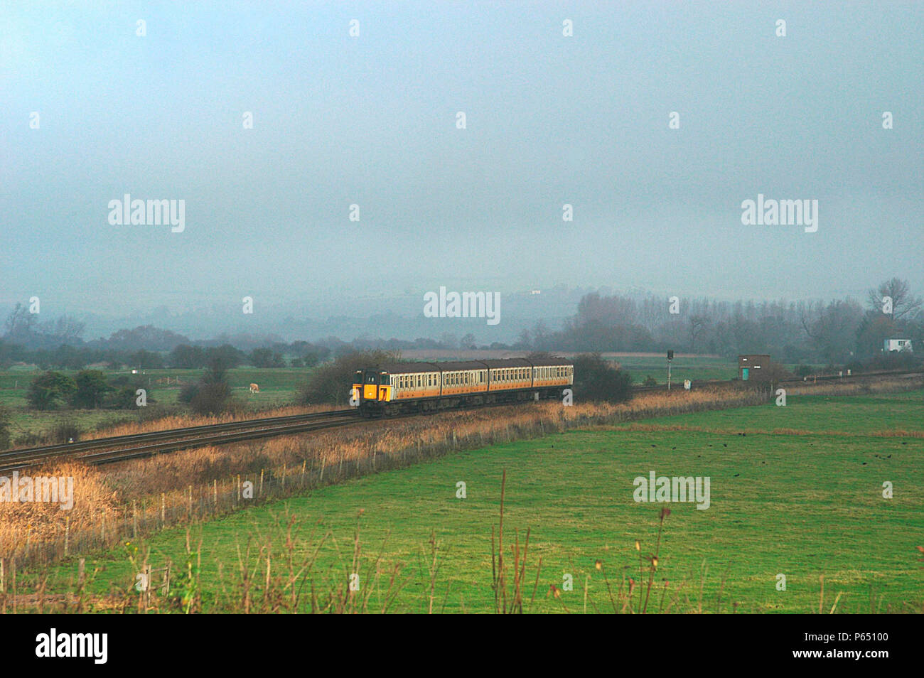 A Connex liveried EMU with slam door stock speeds through the countryside in the south east of England. 2003 Stock Photo