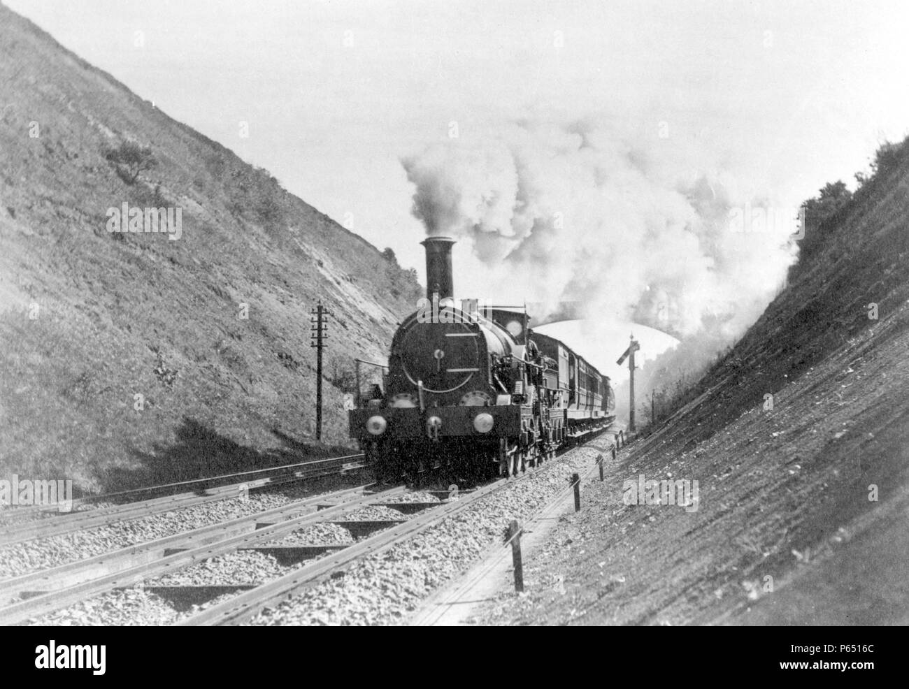 A Great Western Broad Gauge Single passing through Sonning Cutting near Reading. Note the third rail between the tracks to allow standard gauge trains Stock Photo