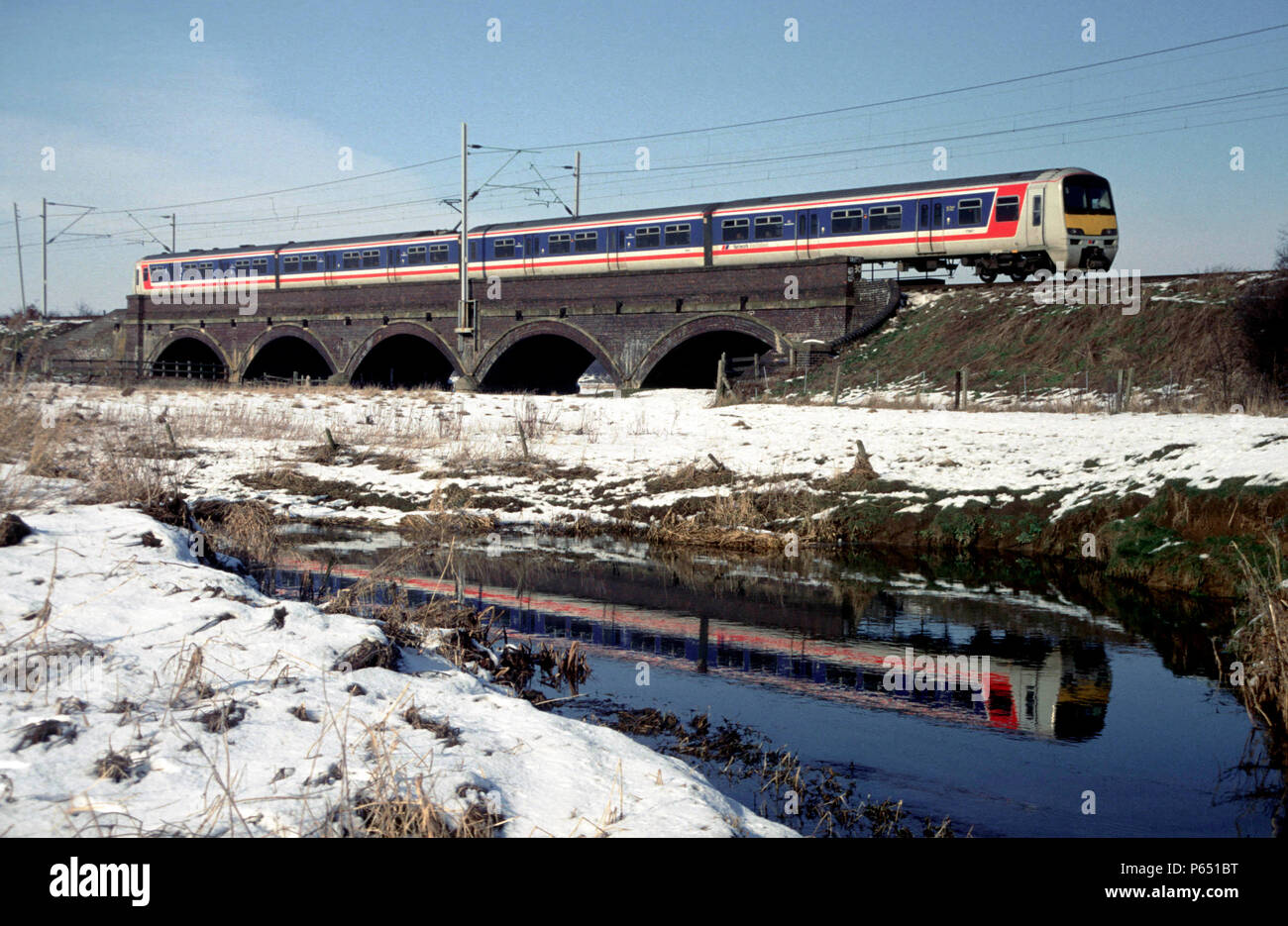 A Network Southeast liveried Class 321 EMU on a Birmingham to Euston service between Rugby and Northampton. Stock Photo