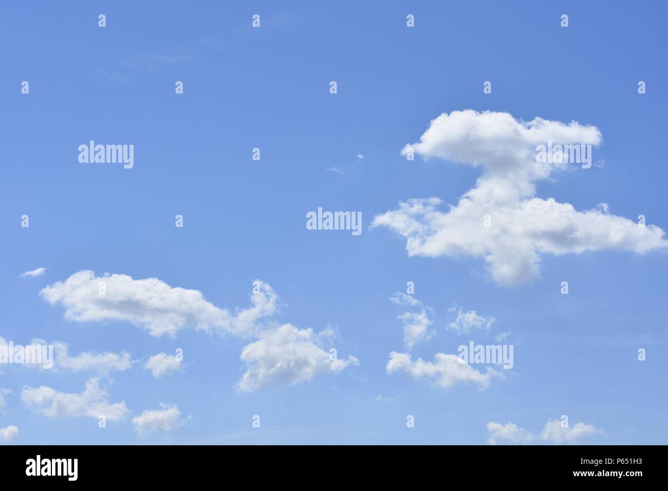 Blue sky with white clouds in different dreamy shapes Stock Photo