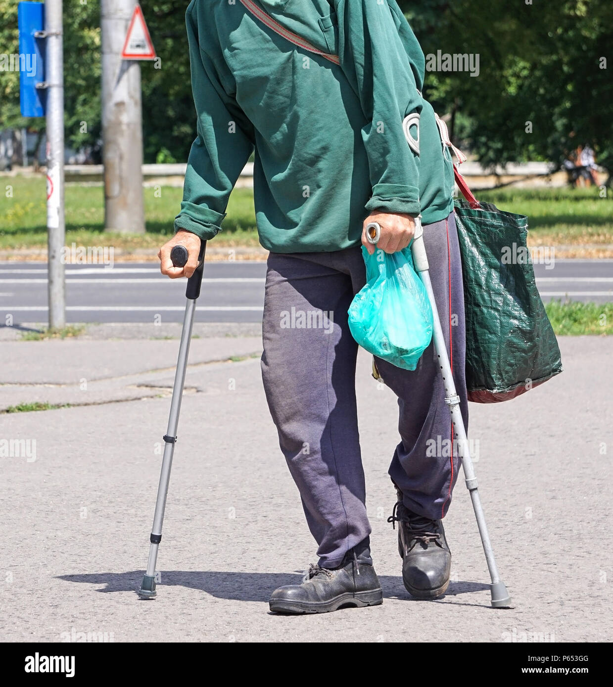 Old man walks with crutch on the street Stock Photo Alamy