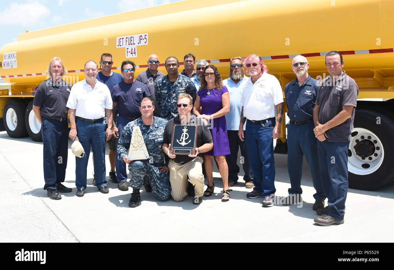 160503-N-SX614-017  KEY WEST, Florida (May, 4, 2016) Naval Supply Systems Command Fleet Logistics Center Jacksonville’s Key West Detachment Staff and Sailors pose near a refueling truck with the Naval Retail Fuel Activity of the Year Award for superior fuel support in 2015 on Naval Air Station Key West’s Boca Chica Field. The detachment performed more than 15,000 fuel transactions involving 21.1 million gallons of fuel, and twice set the single-day fuel sales record, with no spills and zero flight interruptions. Key West is a state-of-the-art facility for air-to-air combat fighter aircraft of  Stock Photo