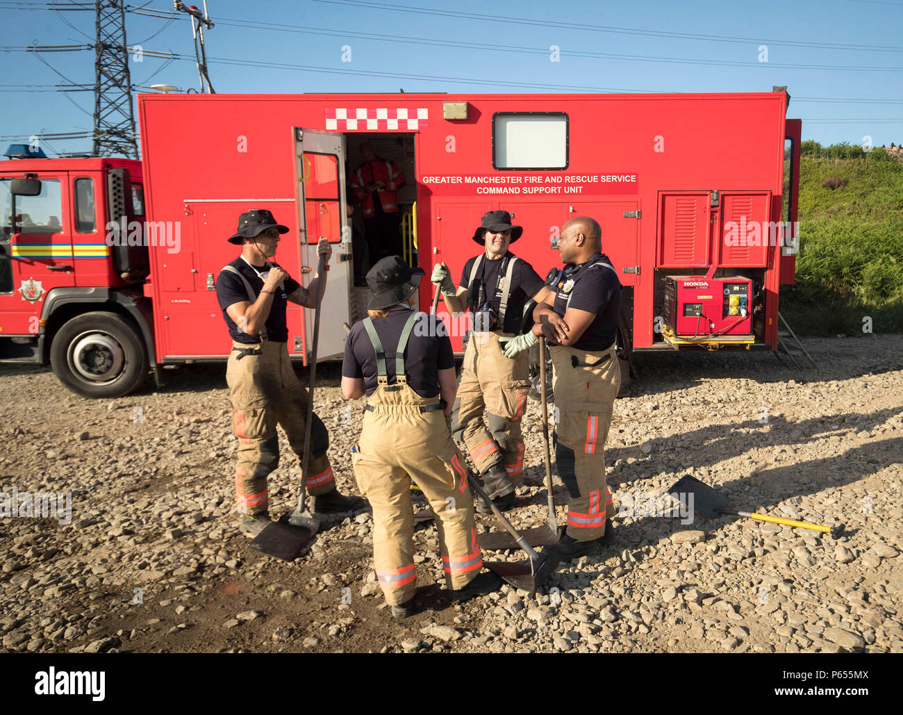 Firefighters prepare to tackle the wildfire on Saddleworth Moor, which continues to burn as they try to quell multiple pockets of flames spanning up to 3.7 miles. Stock Photo