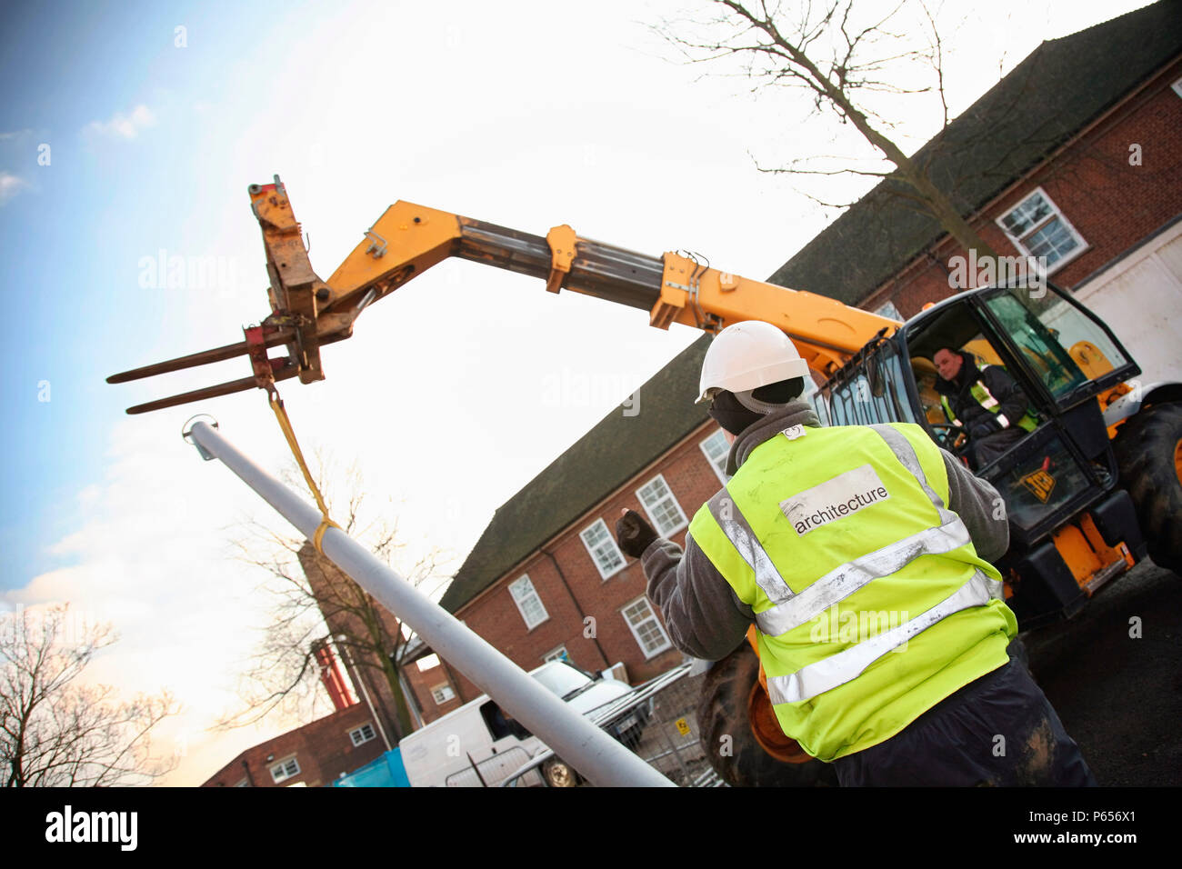 Telescopic forklift lifting streetlight into position Stock Photo Alamy