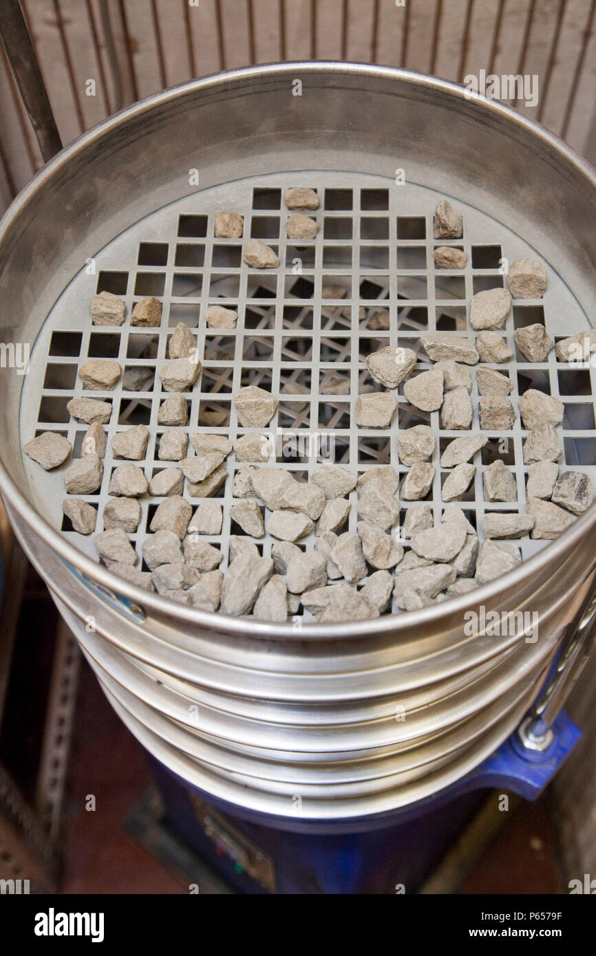Sieves showing the different size materials from a test sample separated during the aggregate sieving process, using the mechanical aggregate sieving  Stock Photo