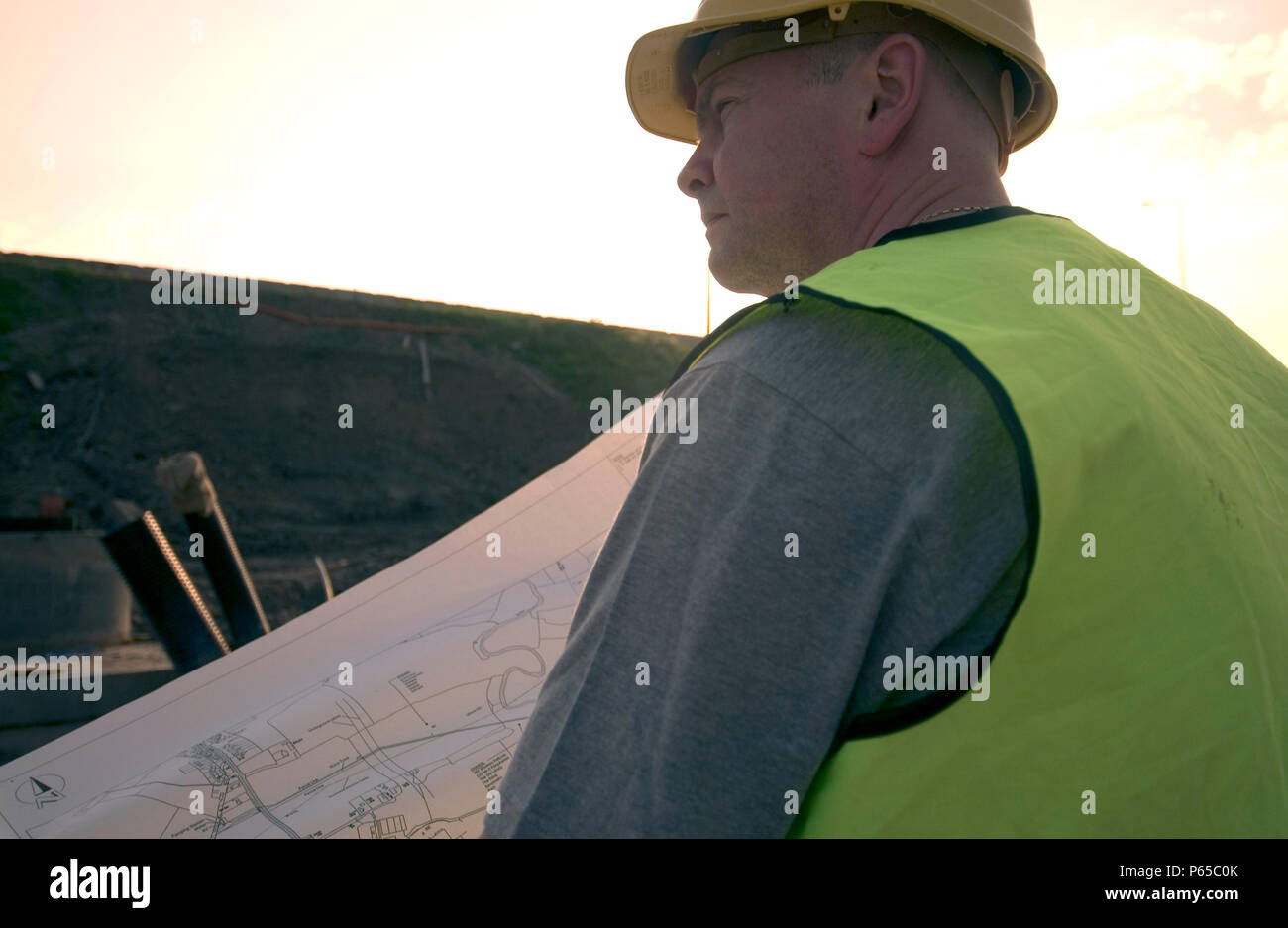 Building technician checking plan on site Stock Photo