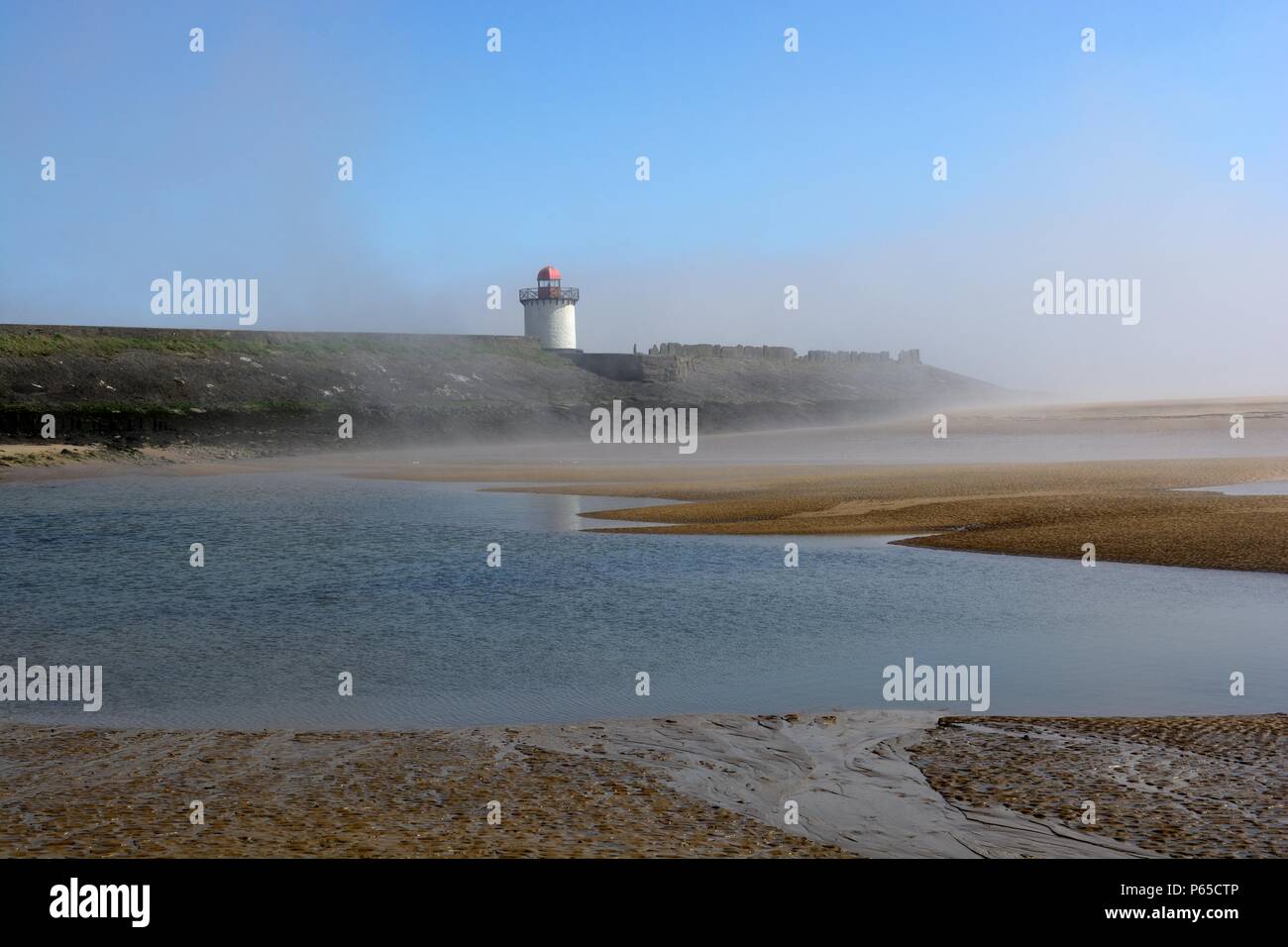 Sea mist over Burry Port Lighthouse and Burry Esruary Carmarthenshire Wales Cymru UK Stock Photo