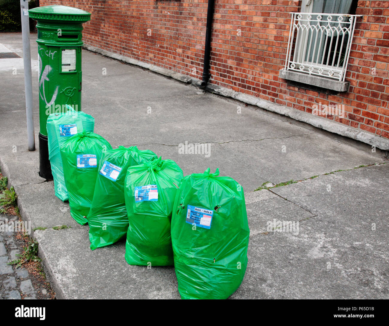 Refuse sacks awaiting collection, Dublin, Ireland. Refuse collection is paid for with tags which you buy in advance and attach to the bin or refuse sa Stock Photo