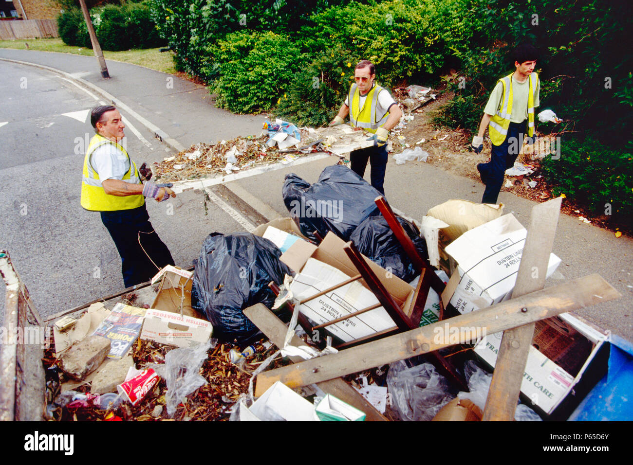 Dustmen working for the local council refuse collection service