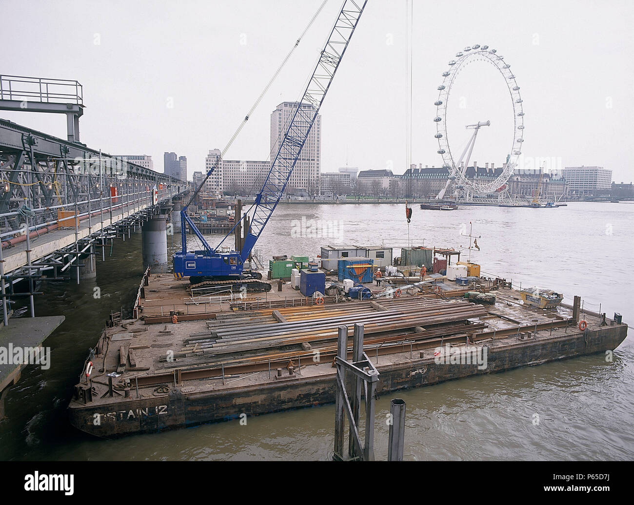 Barges during construction of new Hungerford footbridge. London, United