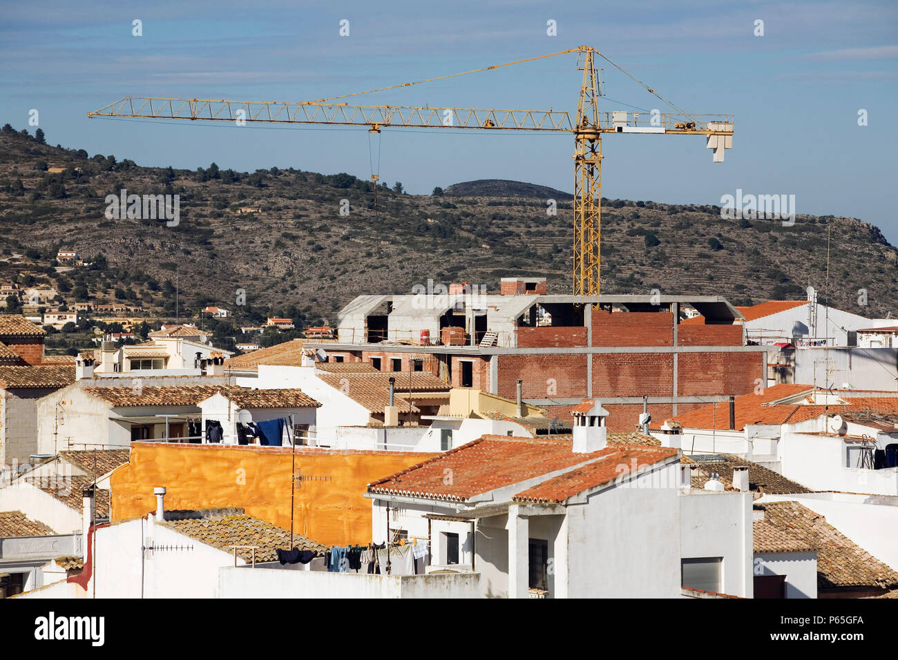 Building crane in the village of Benissa, Costa Blanca, Spain Stock Photo