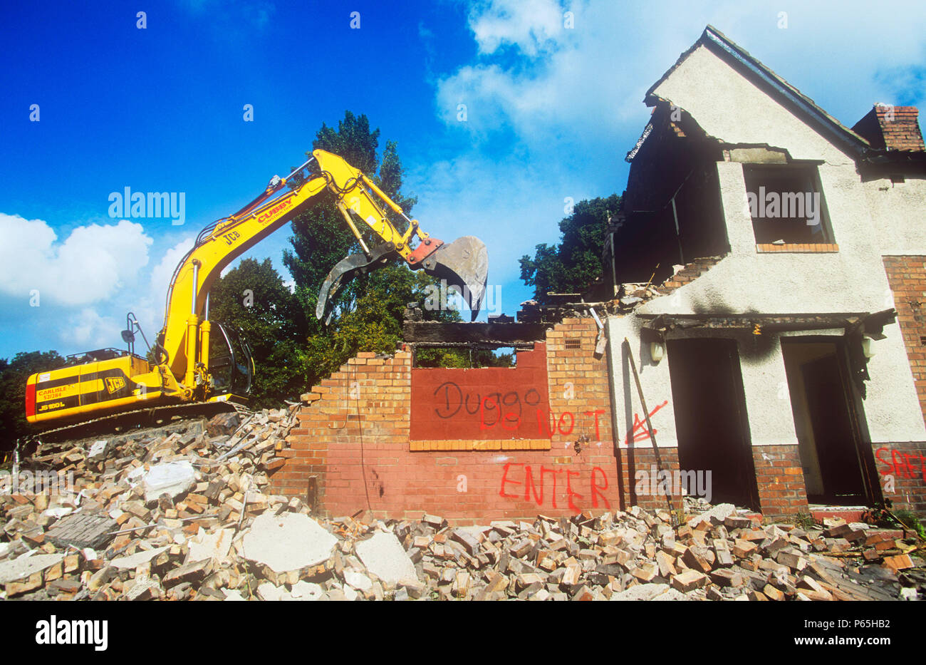 Demolishing old council houses on the Raffles sink estate in Carlisle, Cumbria, UK Stock Photo