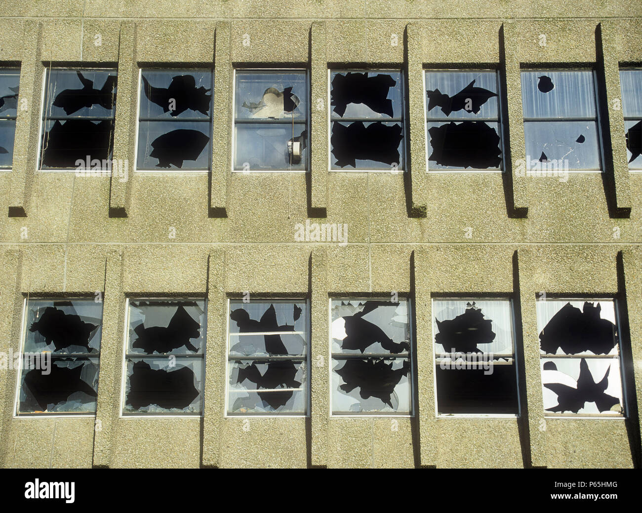 Smashed windows in a derelict building in oldham, lancashire, UK. Stock Photo