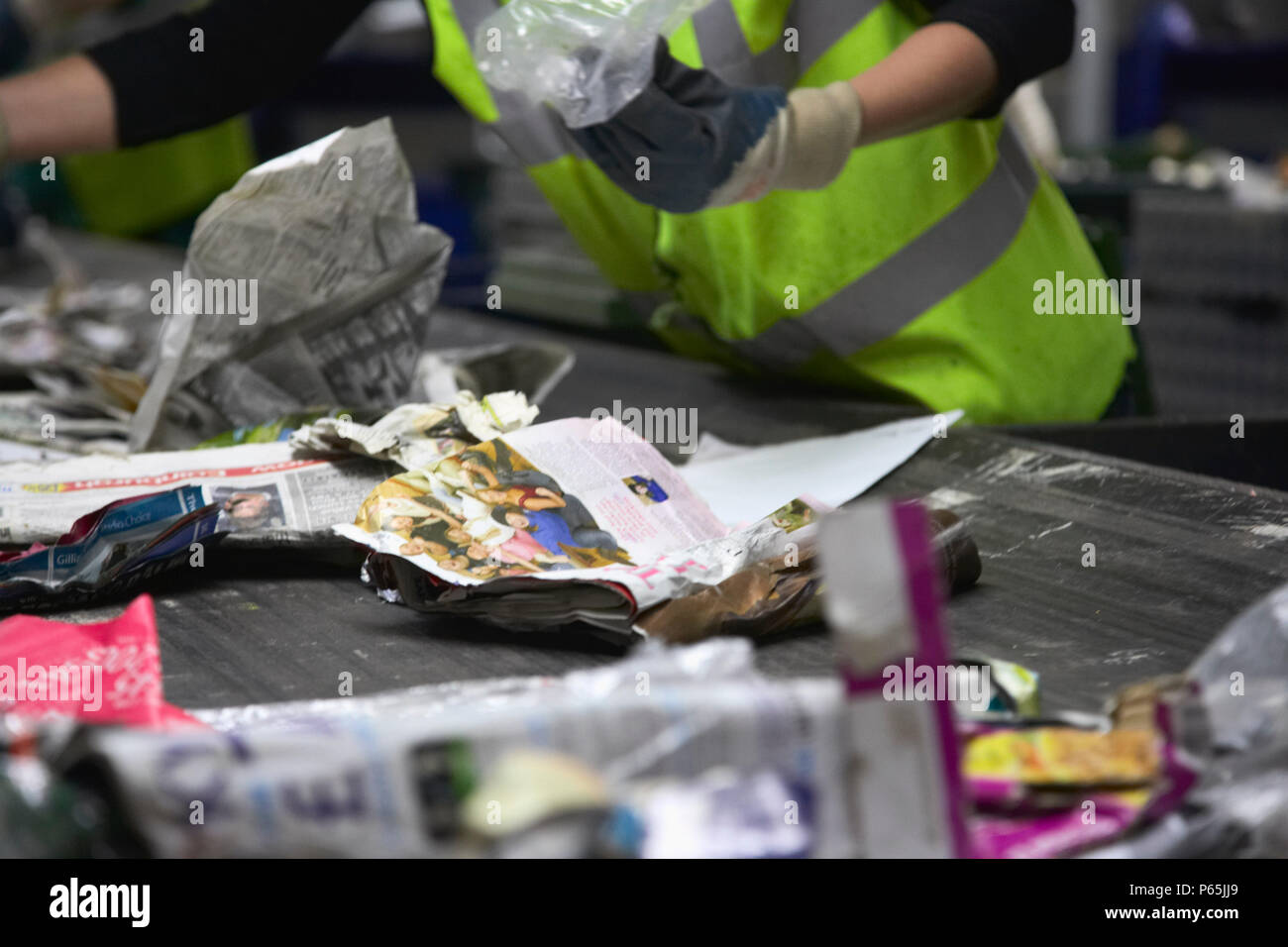 Recycling being sorted on conveyor belt Stock Photo
