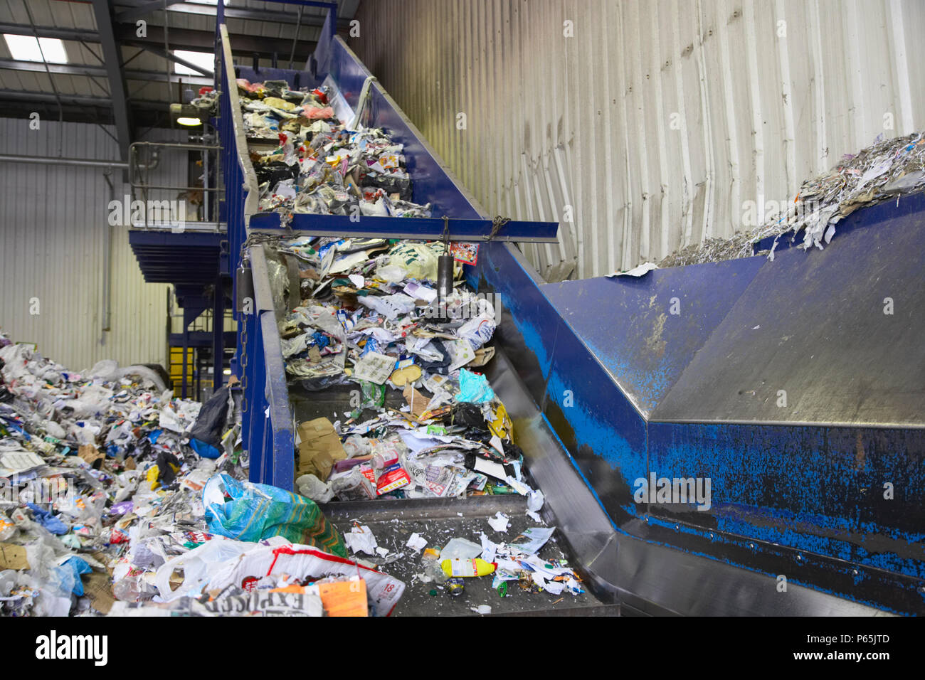 Conveyor belt taking recycling from dumping bay into sorting area Stock