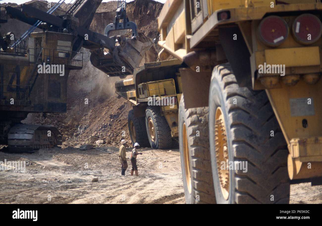 Biggest quarry trucks in the world at open cast copper mine. Zambia
