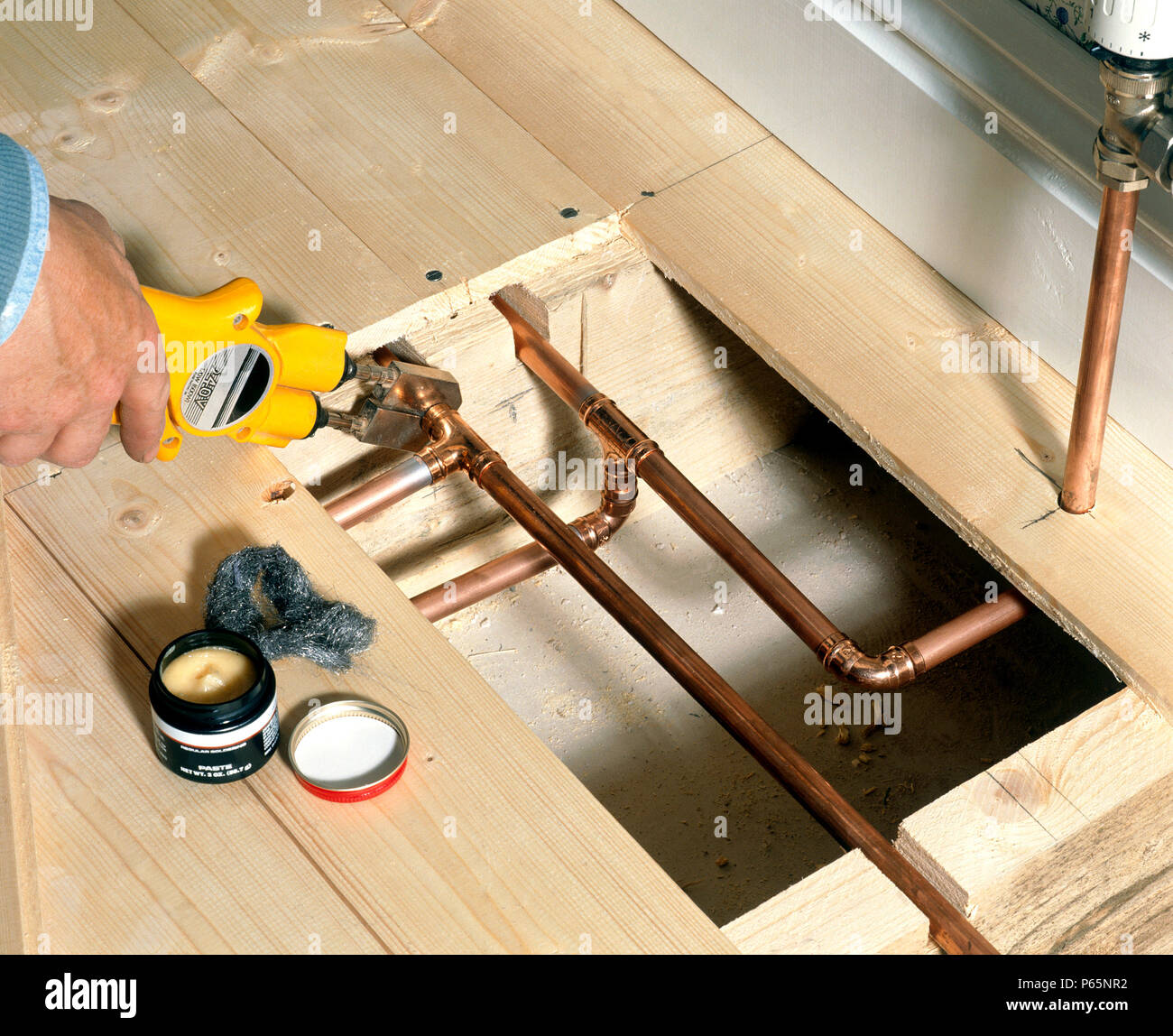 Handyman using pliers to tighten new valve Stock Photo Alamy