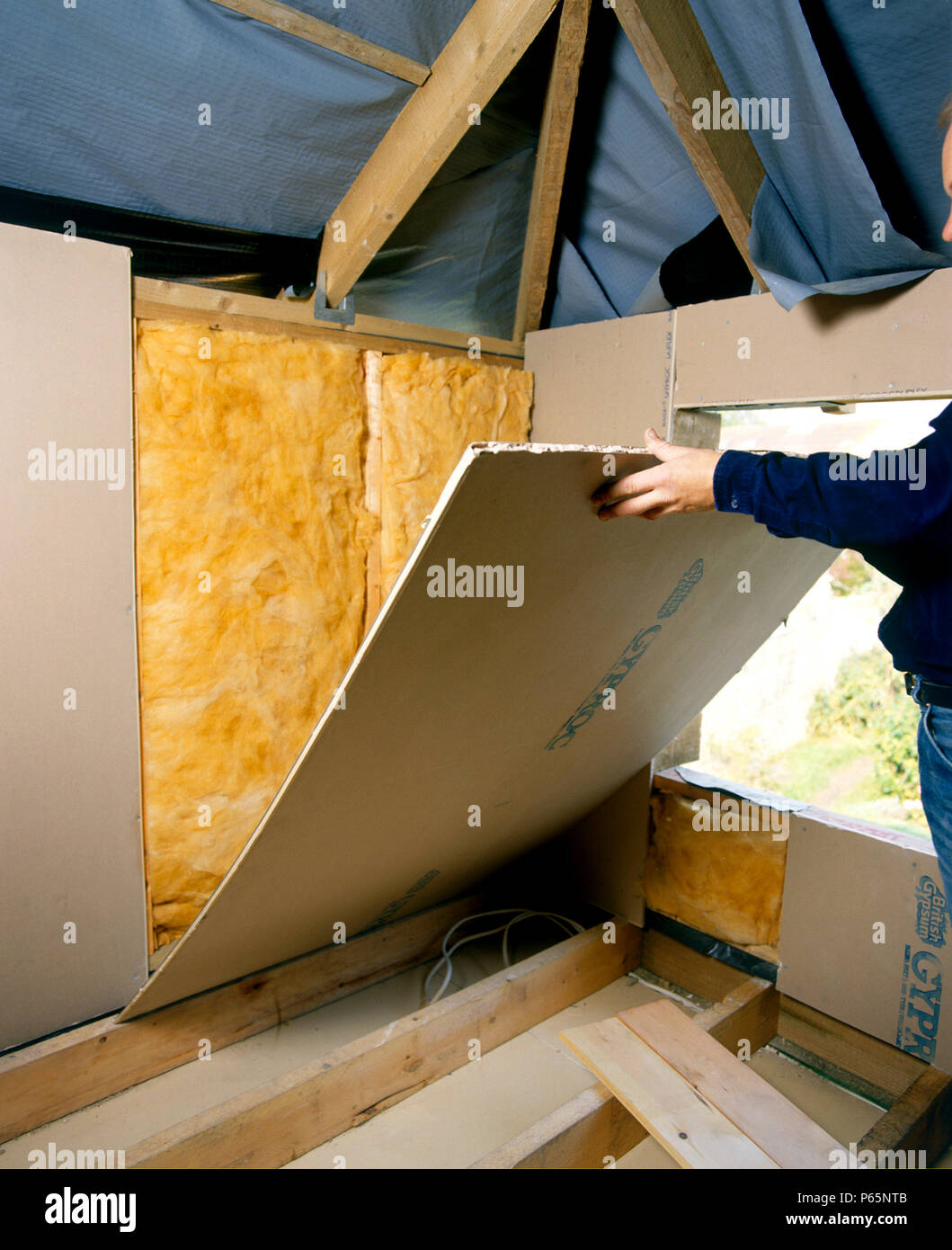 Insulating Installing Quilt Loft Insulation To A Roof Space Stock