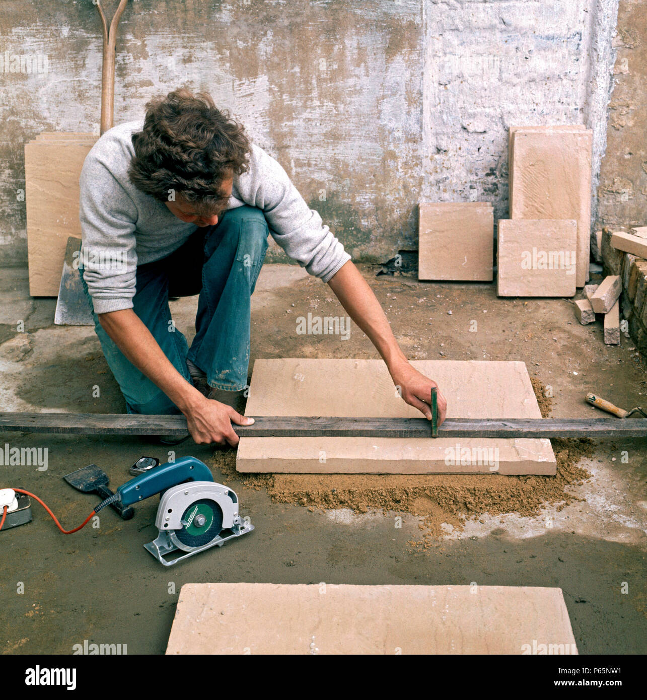 Laying slabs on a patio Stock Photo Alamy