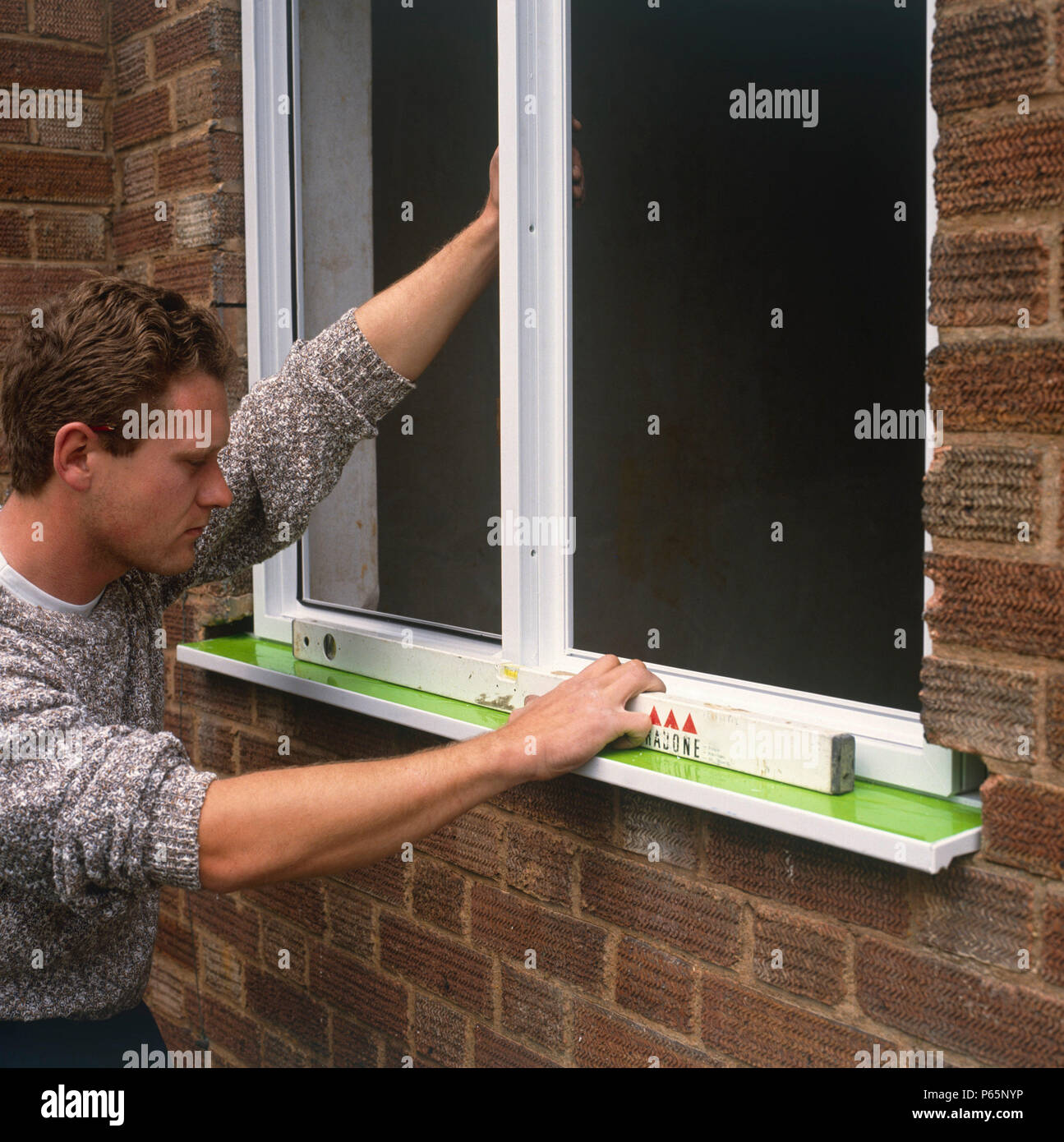 Replacing a damaged window by a new double glazing UPVC window Stock Photo Alamy