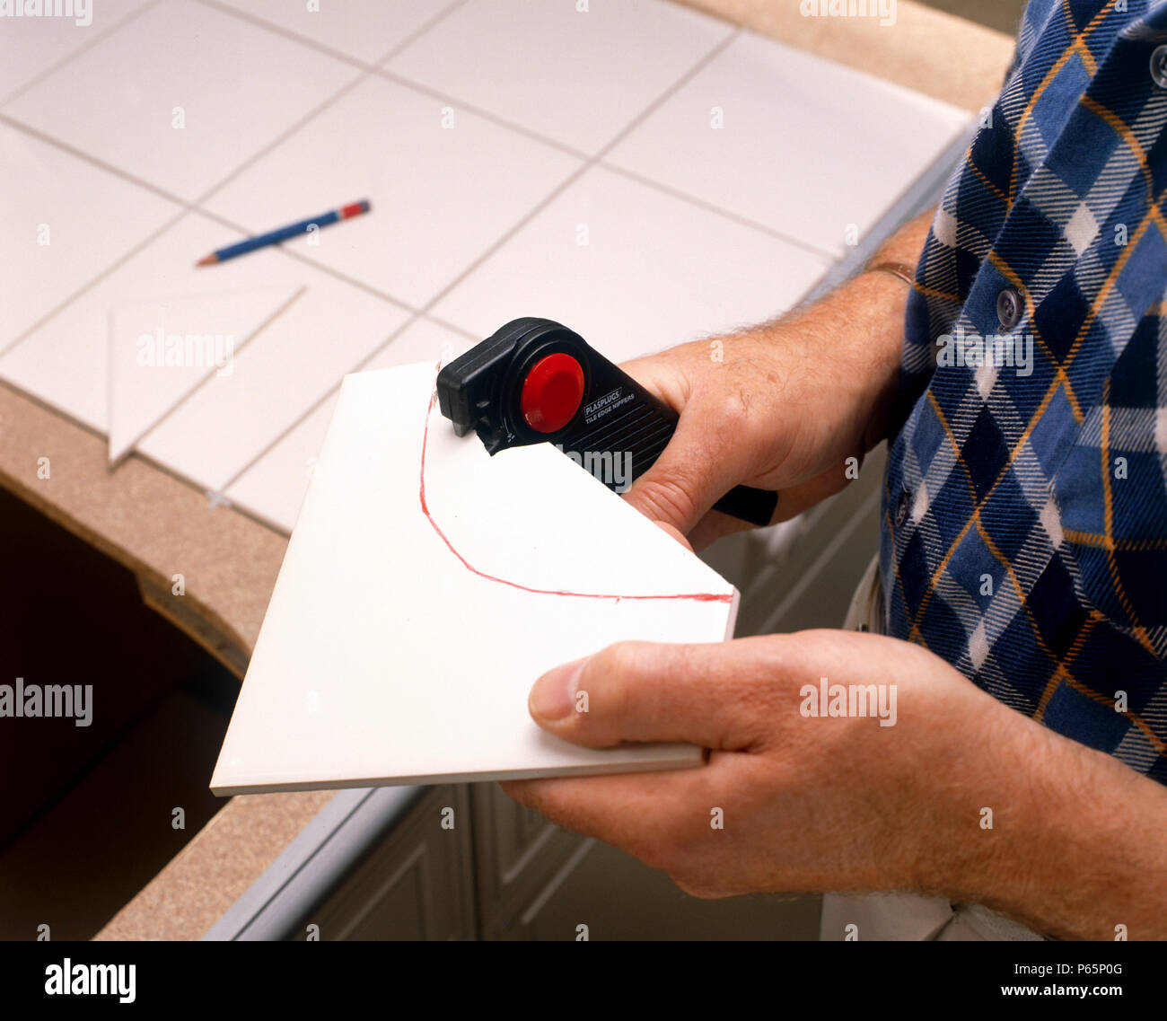 Tiling in progress. Cutting tiles Stock Photo Alamy