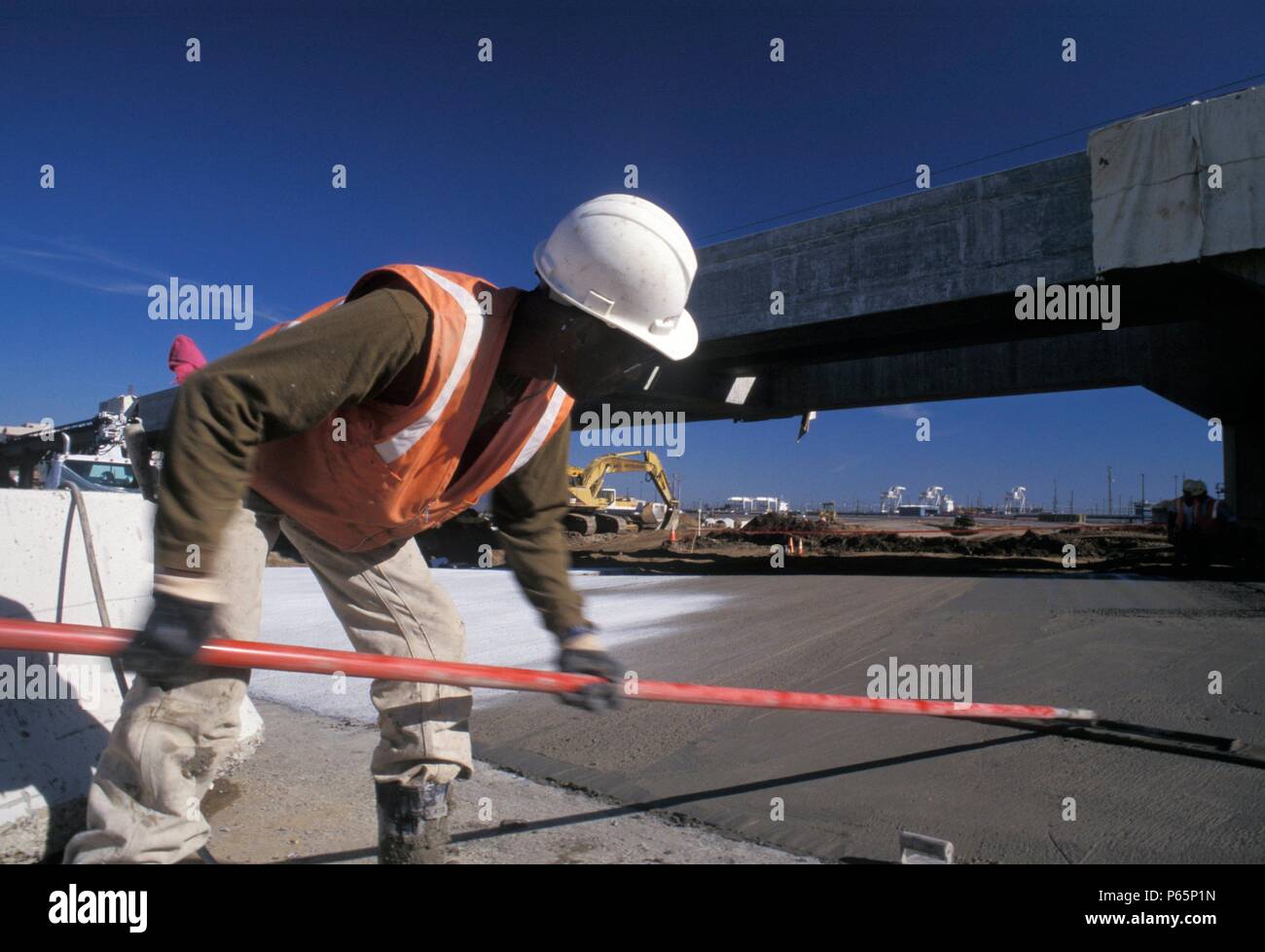 Finishing concrete with long handle float Stock Photo Alamy