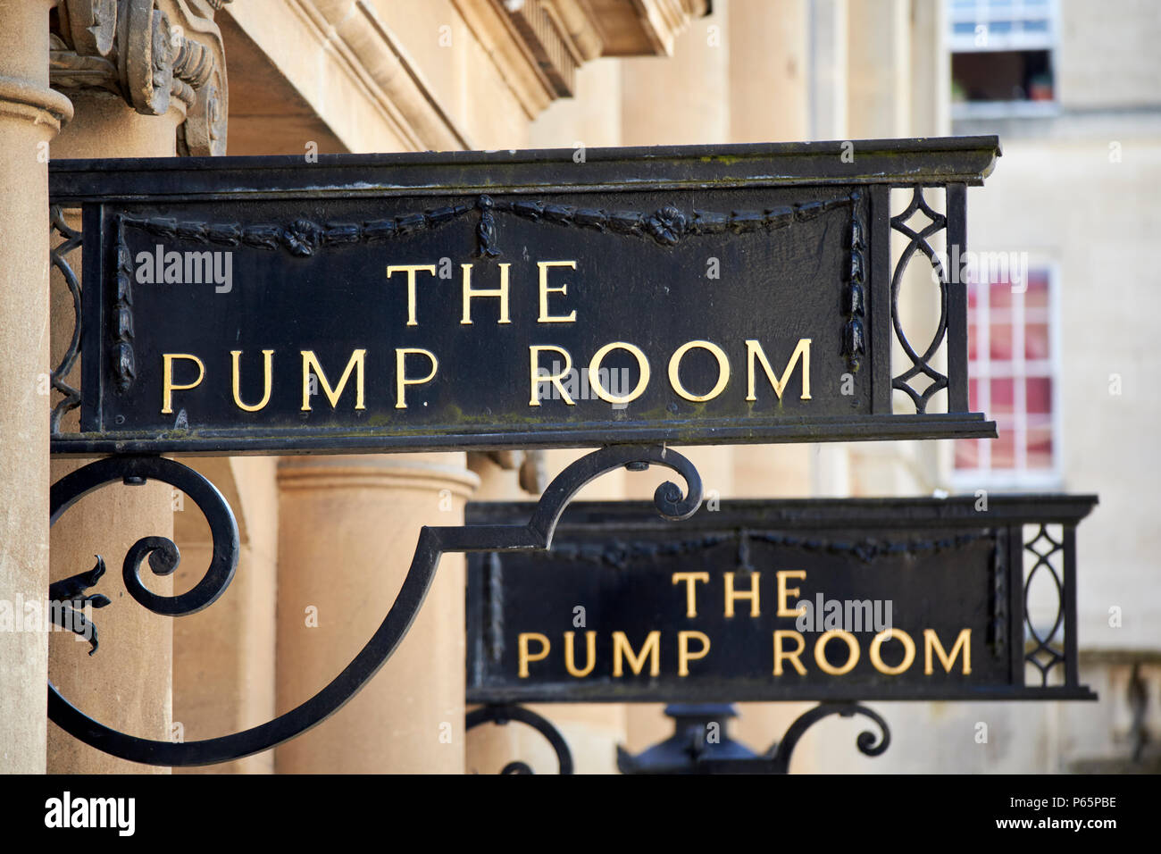 signs for the pump room at the site of the roman baths Bath England UK